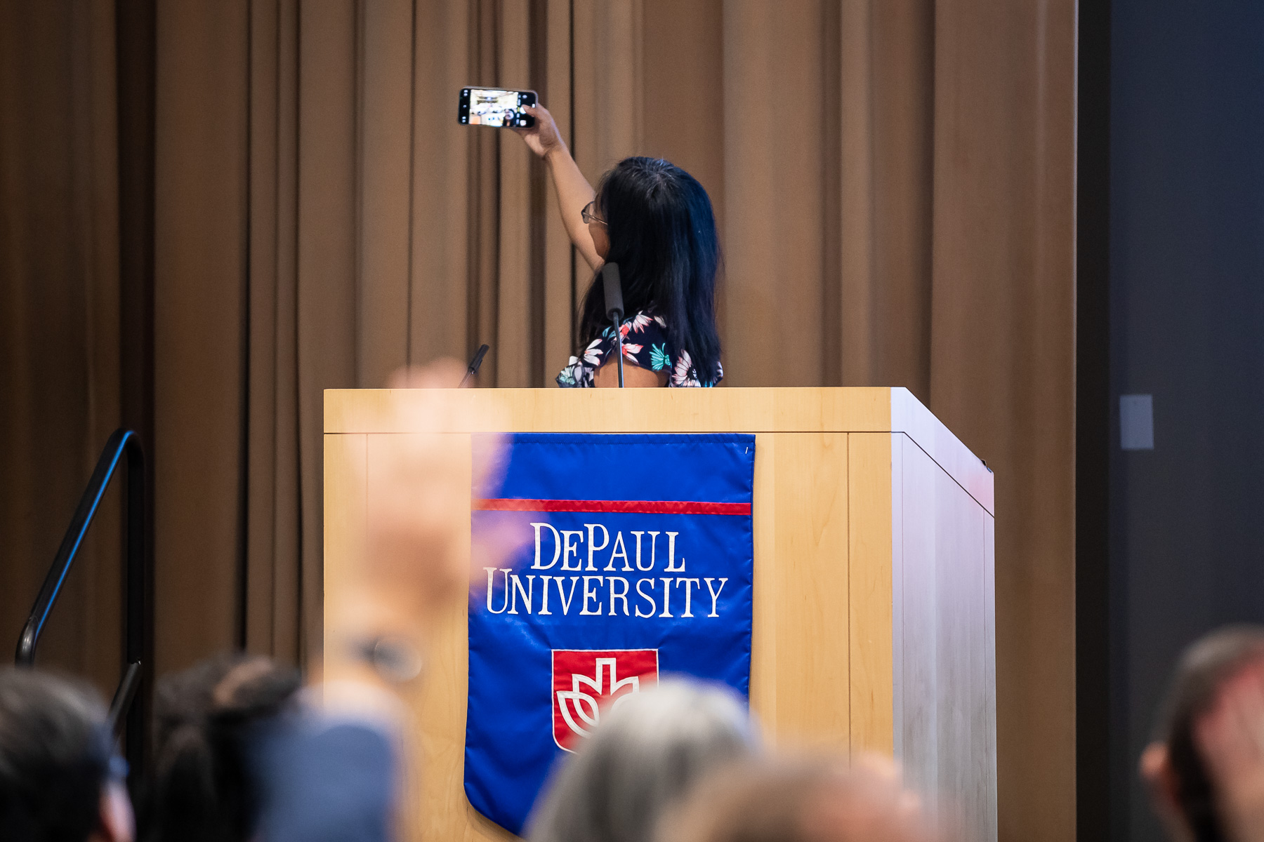 As one of DePaul's social media content editors, Maria Hench takes a selfie of herself and the audience following her speech.